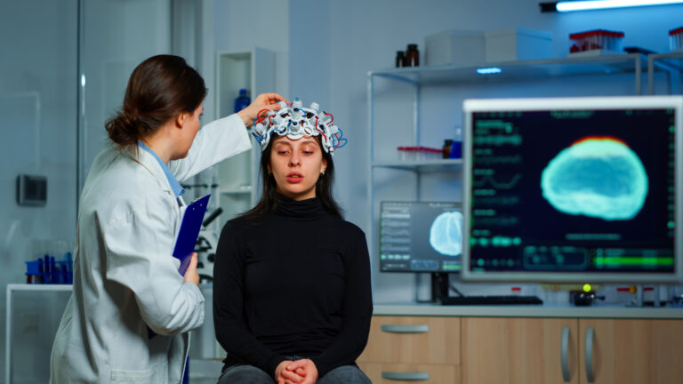 Neurological doctor cheking eeg headset explaining treatment